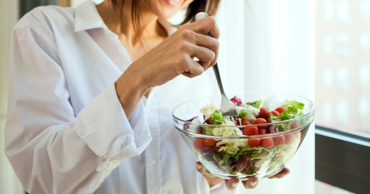 woman eating a salad. More satisfying meals